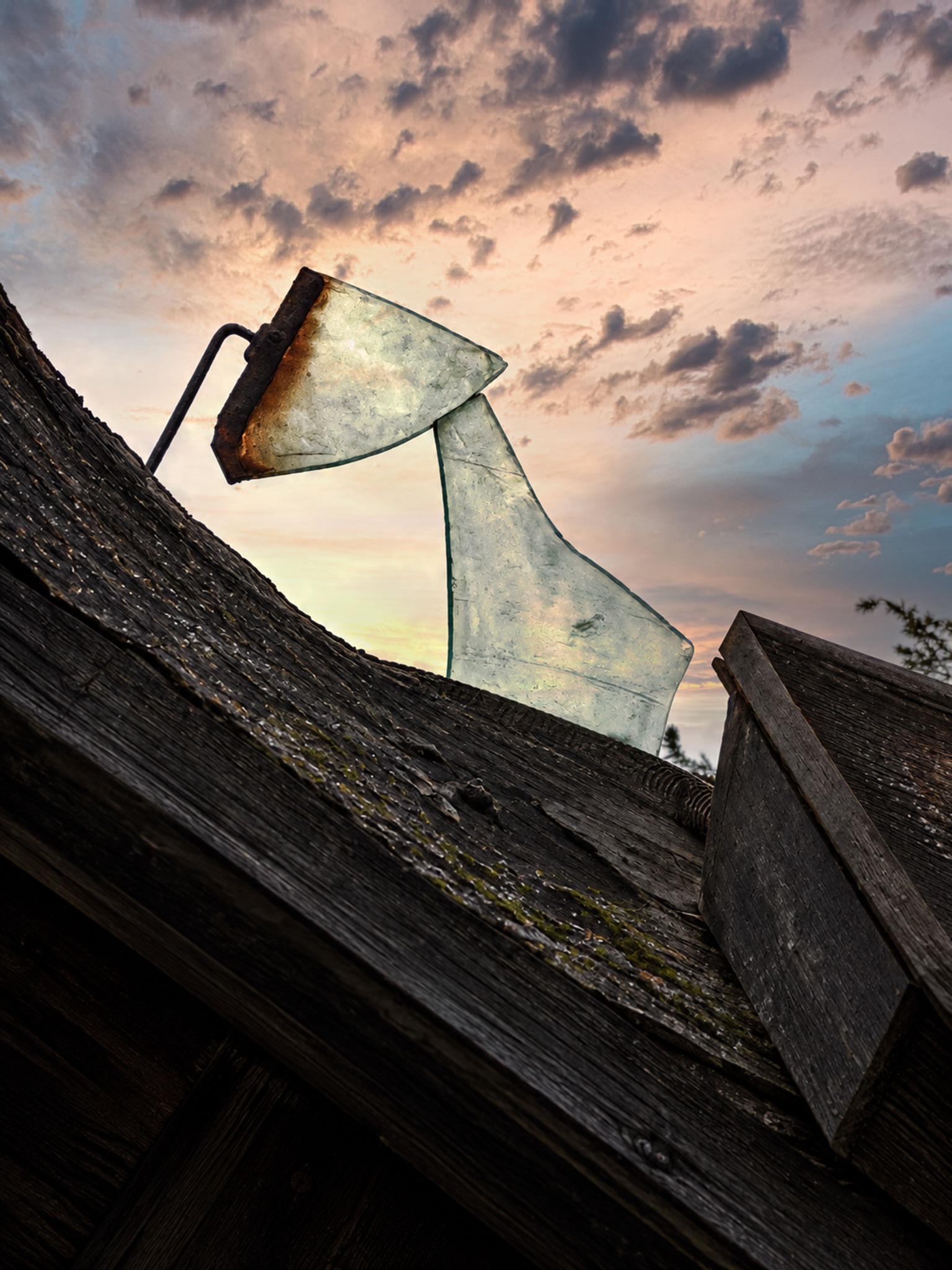 Ancient weathered glass elements rising from dark timber against the sky
