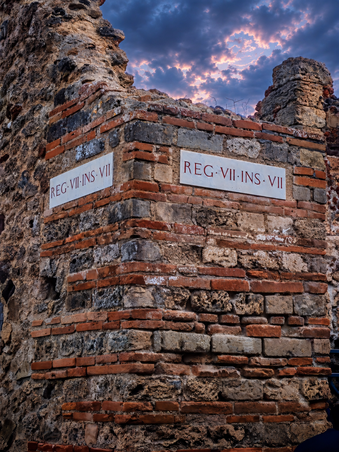 Ancient brickwork with Roman district plaques in Pompeii